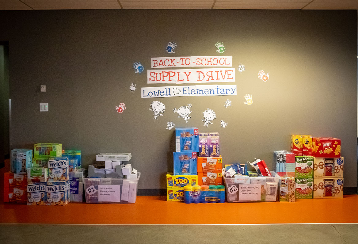 back-to-school-drive snacks and school supplies under supply drive sign